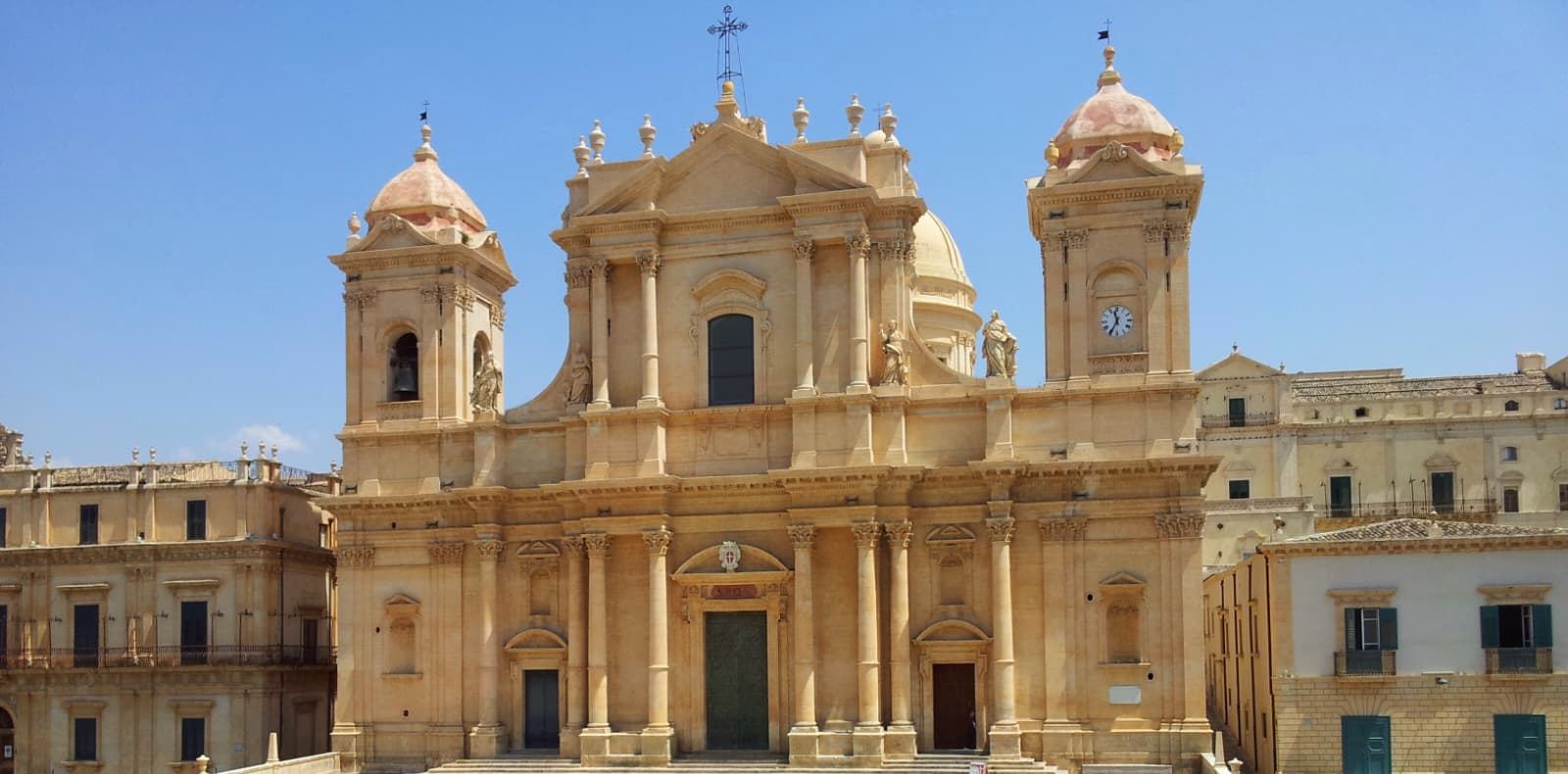 Noto Cathedral of San Nicolò, baroque facade with grand staircase under a blue sky